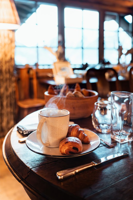 A hot cup of coffee and croissants fresh made for breakfast.